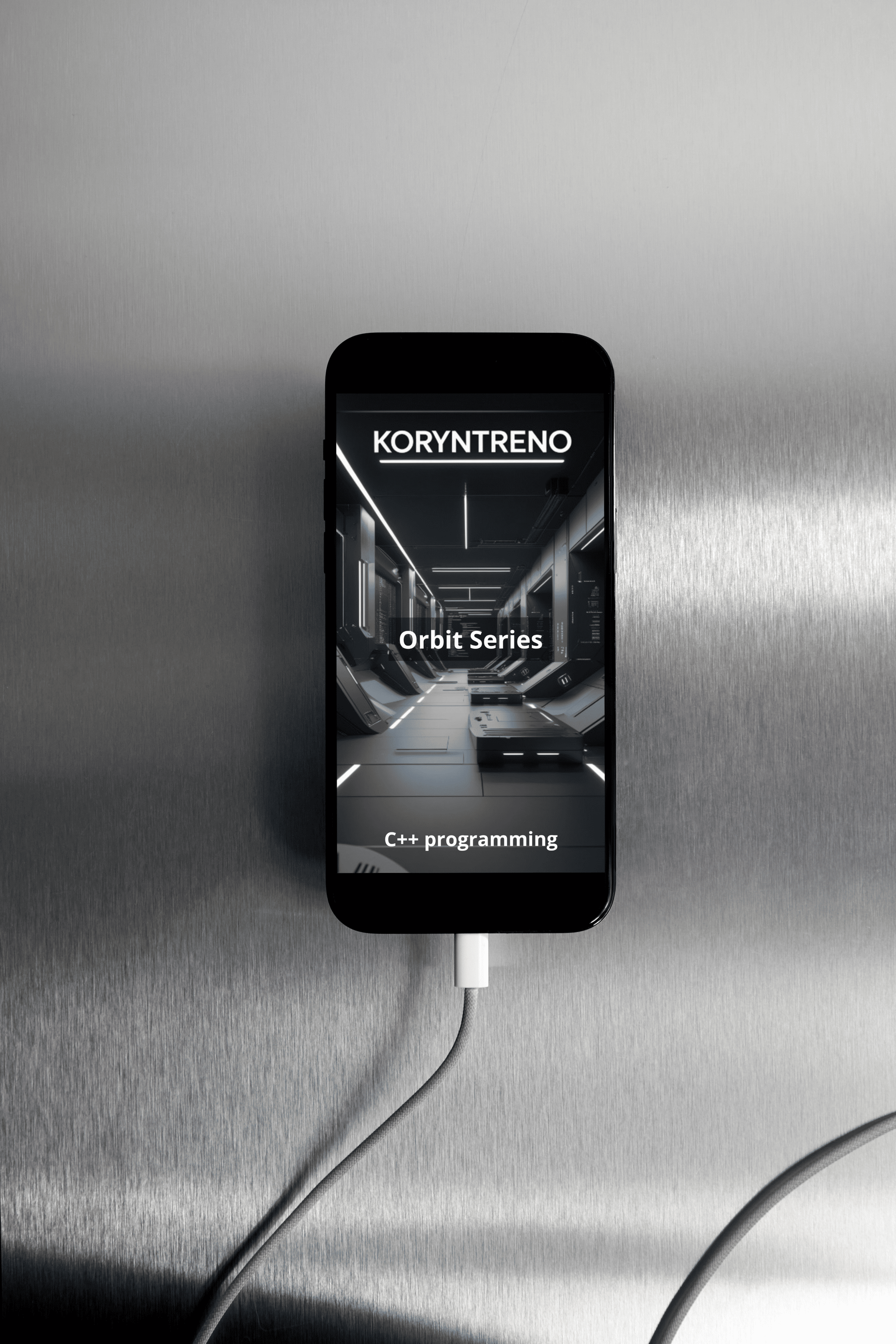 Phone with Koryntreno cC++ course 'Orbith Series' isplayed on a metallic surface