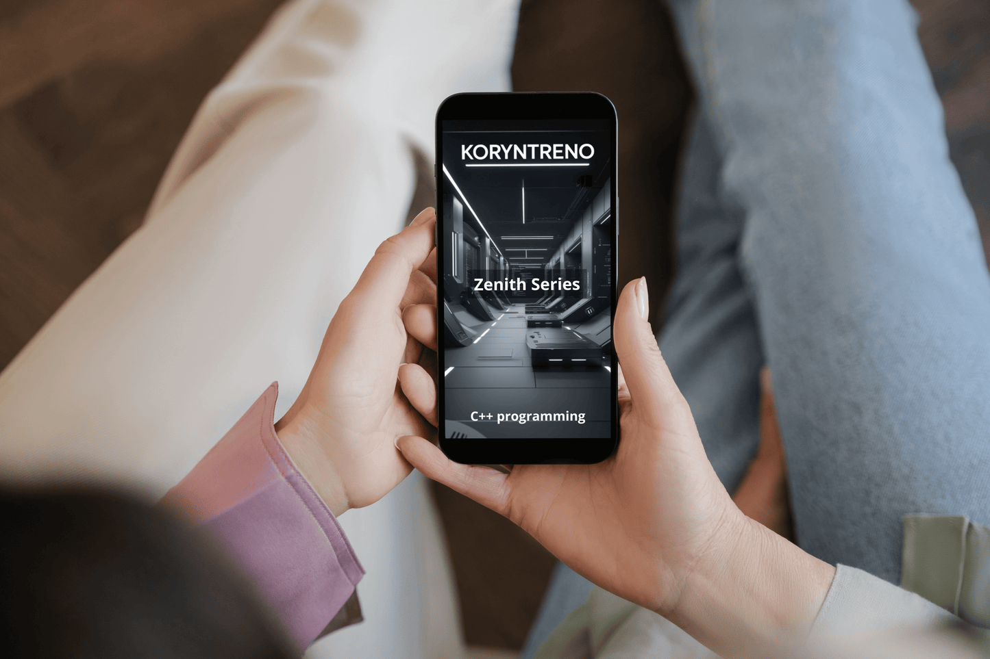 Person holding a smartphone displaying the Koryntreno app with a focus on 'Zenith Series' and 'C++ programming'.